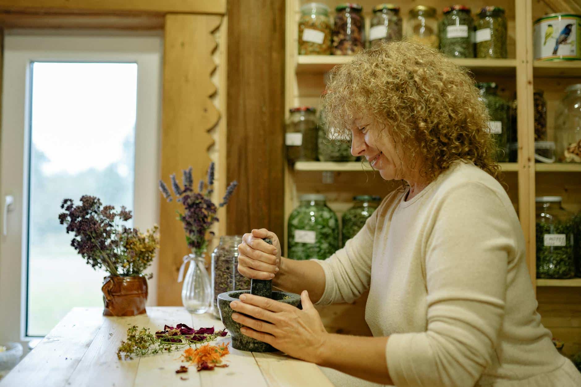 woman mixing herbs in pounder